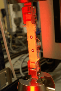 Tensile testing of a woven aramid fibre